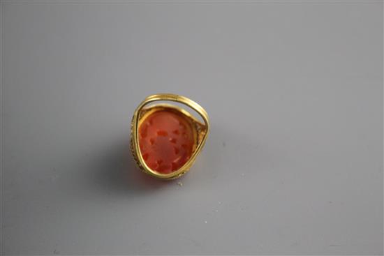 A 14k filigree yellow metal and orange chalcedony set dress ring, carved with fruit, size M, gross weight, 6 grams.